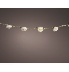 A gorgeous white rose garland with foliage and micro LED lights.