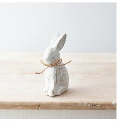 A charming polyresin bunny ornament with a distressed finish and cute jute bow.