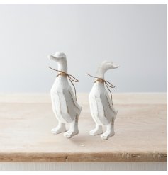 A charming polyresin duck ornament with a white washed finish and rustic details. Complete with jute bow.