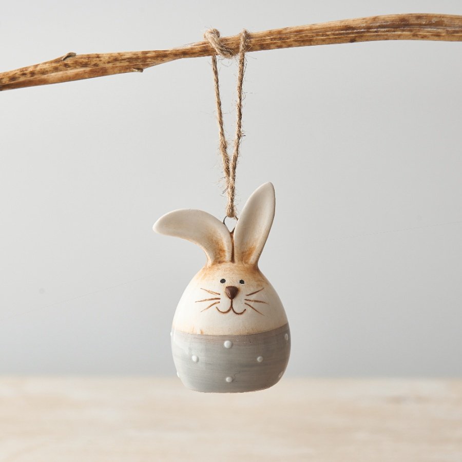 A charming ceramic Bunny Egg with a polka dot base and jute string hanger. Beautifully detailed with a shiny glaze