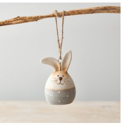 A charming ceramic Bunny Egg with a polka dot base and jute string hanger. Beautifully detailed with a shiny glaze