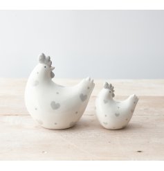 A charming chicken ornament with grey polka dot hearts.