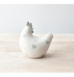 A stylish grey and white chicken ornament with polka dots and hearts.
