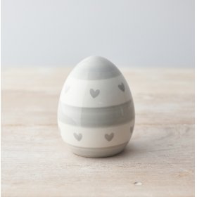 A chic egg ornament decorated with a grey heart and stripe pattern. 