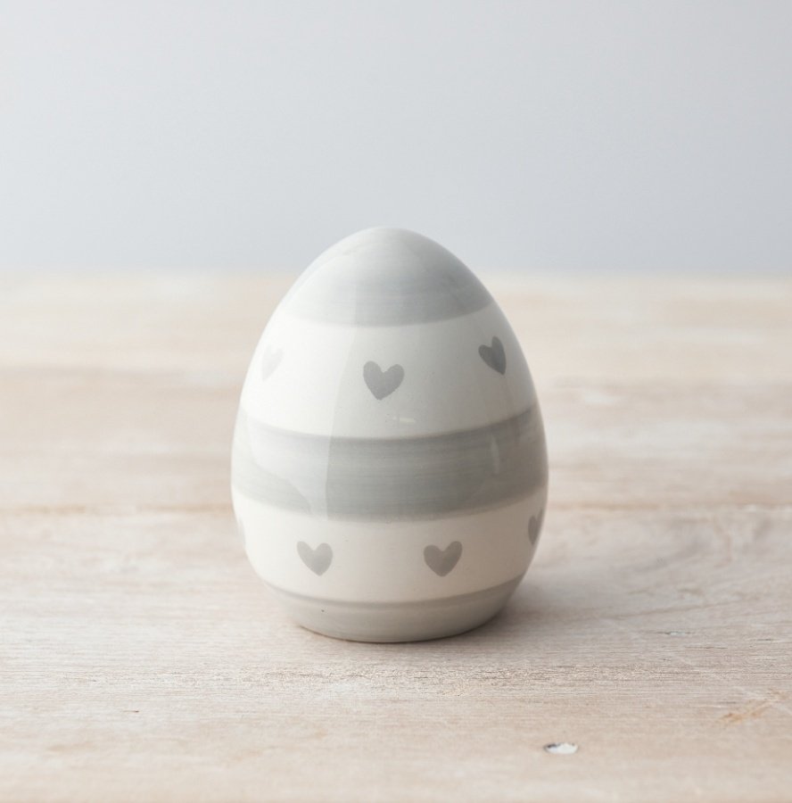 A chic egg ornament decorated with a grey heart and stripe pattern. 