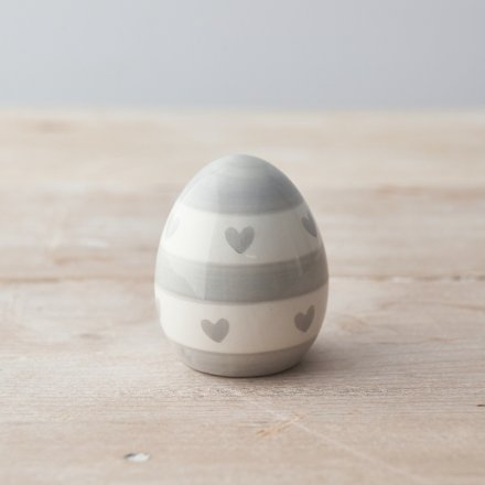 A chic grey and white egg decoration with a stripe and heart painterly pattern.