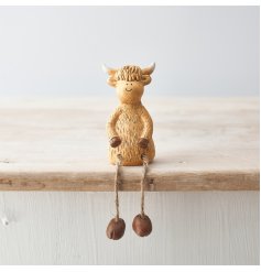 A charming highland cow shelf sitting ornament. A rustic interior decoration and gift item.
