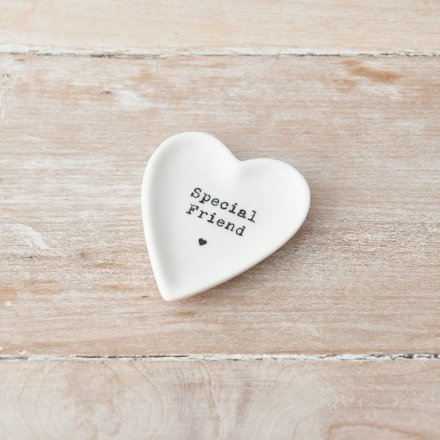 A heart shaped dish with a Special Friend slogan and heart stamp. 