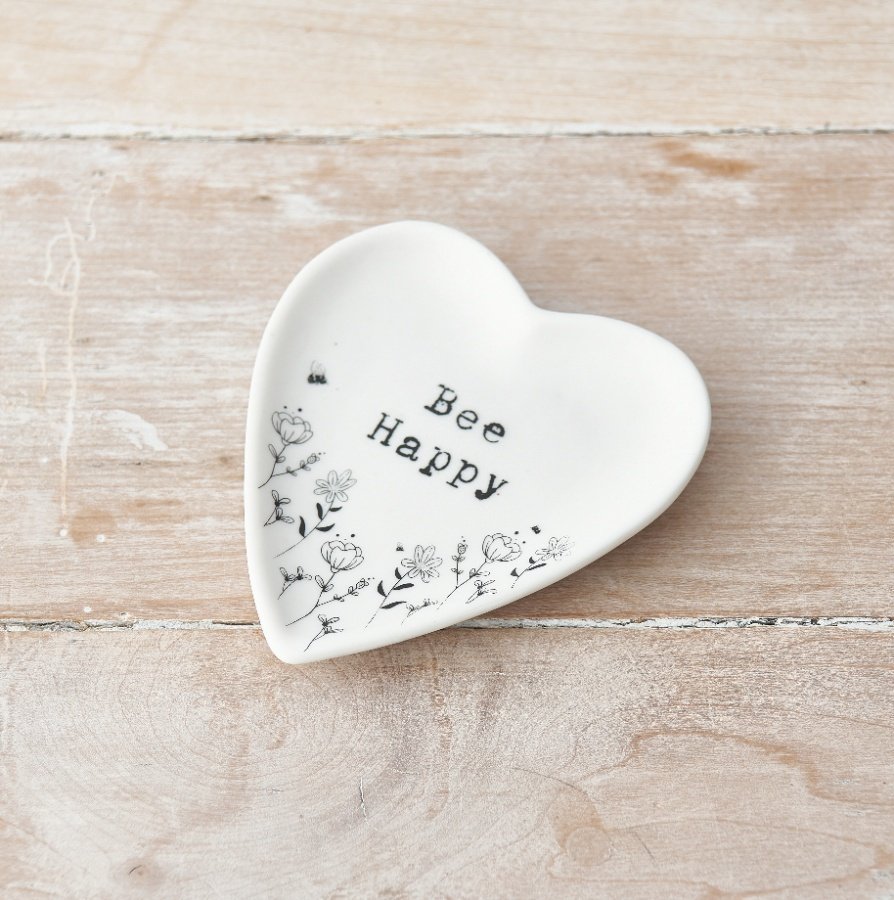 A heart shaped trinket dish decorated with a pretty floral design. Complete with a stamp style slogan.