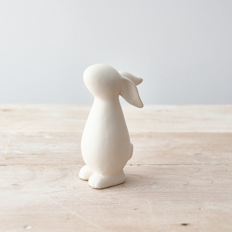 A charming bunny ornament with a white matte finish. A contemporary seasonal gift item for the home.