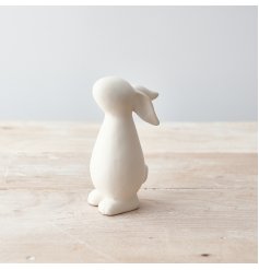 A charming bunny ornament with a white matte finish. A contemporary seasonal gift item for the home.
