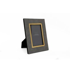 A chic photo frame with a gold edge and grey woven design.