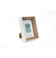 A stylish wooden photo frame with floral insert. A deep box frame with a white outer edge and wooden frame.