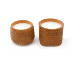 An assortment of 2 ceramic candle pots, each with a carved rattan style finish. A stylish accessory for the home.