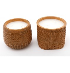 An assortment of 2 chunky candle pots with a carved rattan effect finish. 