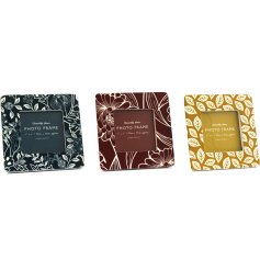 An assortment of 3 square photo frames in earthy blue, red and yellow colours. Each has an artistic floral pattern.