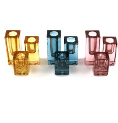 A set of 3 contemporary glass candle holders in rich jewel colours, including pink, blue and ochre. 
