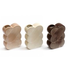 An assortment of 3 tan, cream and brown vases. Each has an abstract shape with engraved arch design and glossy finish.