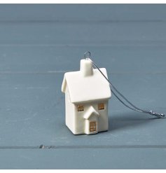 A charming miniature ceramic house in a glossy white colour with gold painted window frames. 