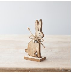 A charming wooden bunny rabbit ornament with small silver bells and a jute string bow. 
