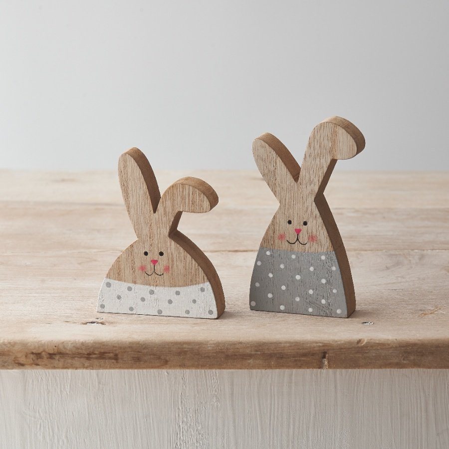 An assortment of 2 wooden rabbit decorations featuring cute little faces and polka dot pattern design. 