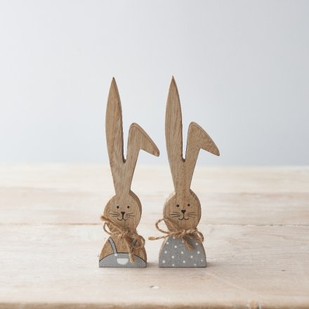 An assortment of 2 wooden bunnies in grey and white painted outfits. Beautifully detailed with jute string bows 