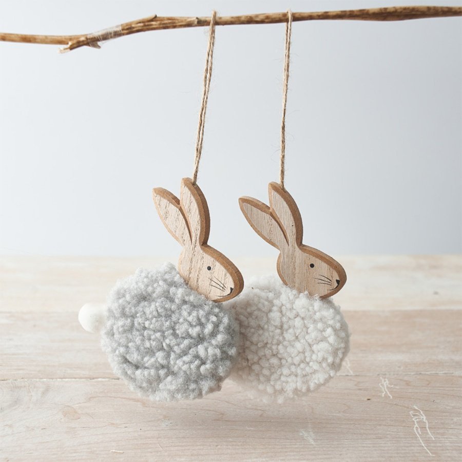 An assortment of 2 chic wooden bunny ornaments, each with a fluffy sherpa body in grey and white. Complete with a cute p