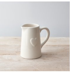 A classic white ceramic jug with an embossed heart detail. 