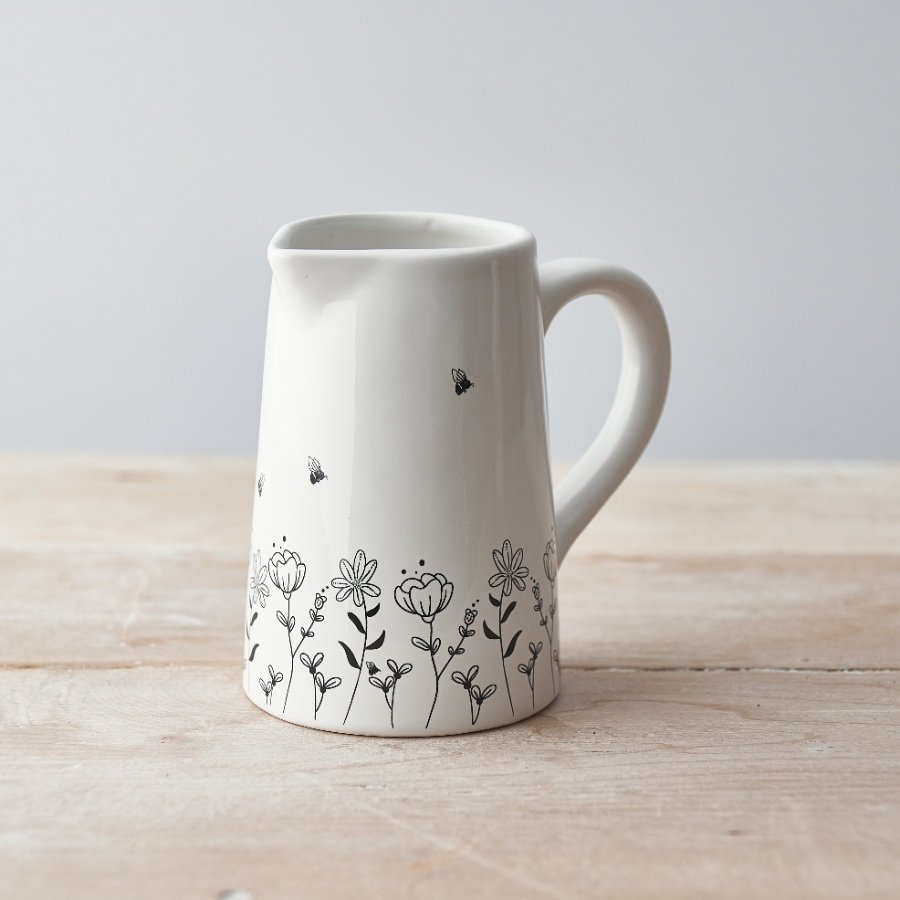 A classically shaped ceramic jug with a pretty wild flower and bee design. 