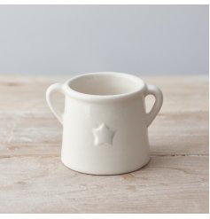 A chic ceramic planter with twin handles and a simple embossed star detail. 
