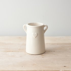 An elegant ceramic planter with twin handles and embossed heart design. 