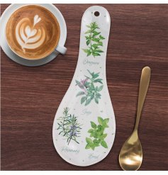 A practical spoon rest with hanging option. Decorated with an assortment of popular garden herbs.