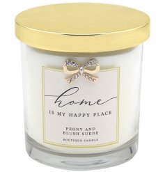 A Peony and Blush Suede scented candle set within an ornate glass jar with bow detail and happy place slogan.