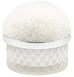 A stunning cut glass candle with a pom pom lid. 