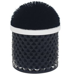 A luxury scented candle with a pom pom lidded glass candle pot.