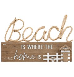 Beach is where the home is. A rustic wooden sign with woven beach detail and charming beach hut. 