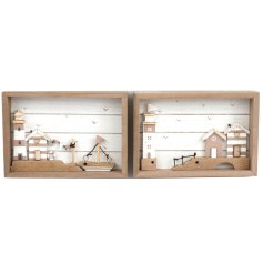 An assortment of 2 charming wooden framed beach scenes. Each featuring beach houses and a light house.