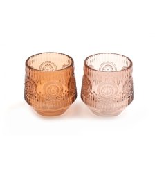 An assortment of 2 richly coloured glass t-light holders, each with an embossed floral design. 