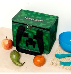 A zip up insulated cooler bag with 2 handles and a Minecraft creeper design. 