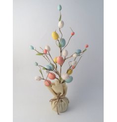 A charming artificial tree decorated with colourful pastel speckled Easter eggs. 