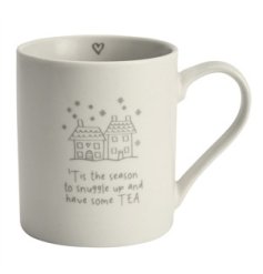 'Tis the season to snuggle up and have some TEA. A chic ceramic mug with a charming tea slogan and sweet house graphic. 