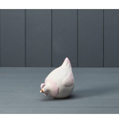 A charming pink and white ceramic chicken ornament. 