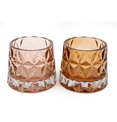 An assortment of 2 tonal glass cut tea light holders in varying shades of amber. 