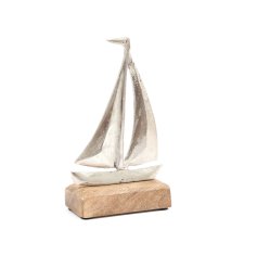 A distressed metal boat on a contrasting wooden base.