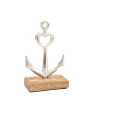 A decorative metal anchor on contrasting wooden base.