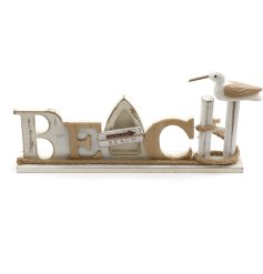 A freestanding wooden "beach" plaque with nautical decorations.