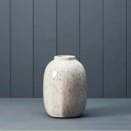 A ceramic vase with speckled pattern.