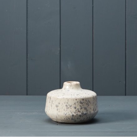 A small vase with grey speckled pattern.
