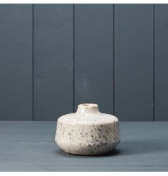 A small vase with grey speckled pattern.