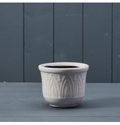 A white ceramic plant pot featuring 3D textured pattern detail.